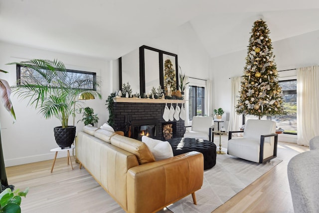 1611 Hill Ridge Ter, Minnetonka, MN 55305 - living room featuring a brick fireplace, light wood finished floors, and high vaulted ceiling