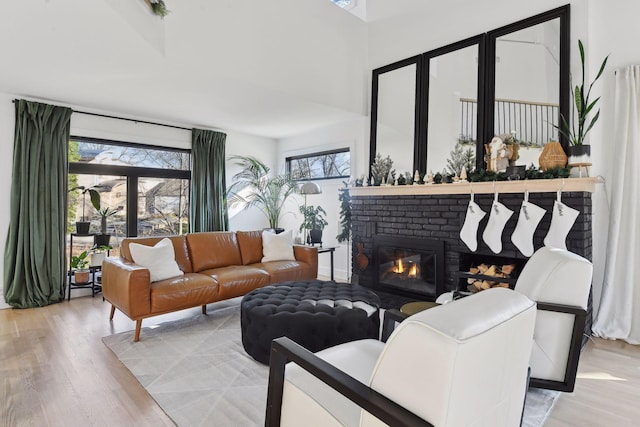 1611 Hill Ridge Ter, Minnetonka, MN 55305 - living room with light wood-style flooring, a fireplace, and a high ceiling