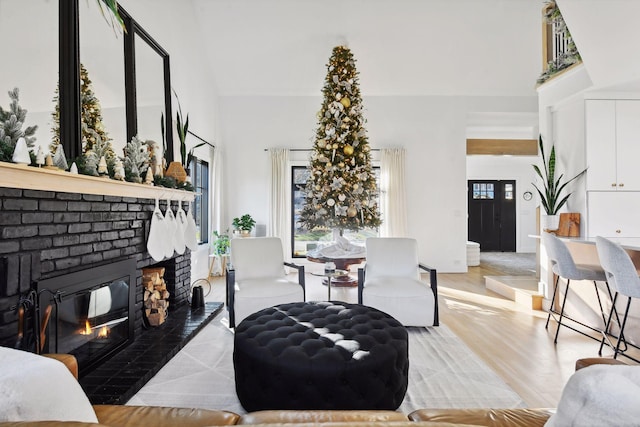 1611 Hill Ridge Ter, Minnetonka, MN 55305 - living room with a brick fireplace, a towering ceiling, and light wood-type flooring