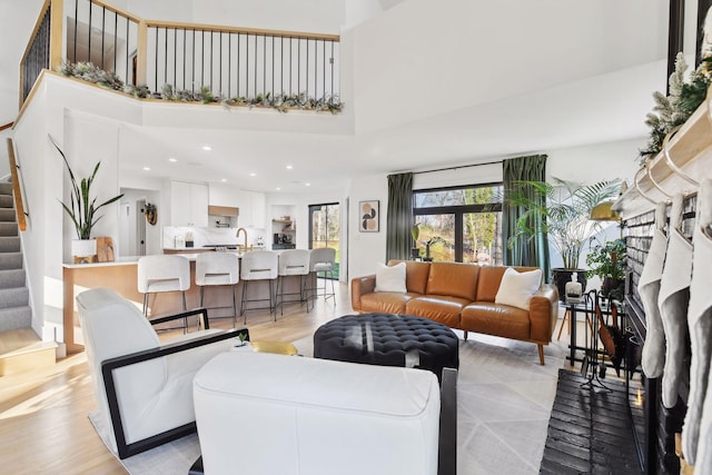 1611 Hill Ridge Ter, Minnetonka, MN 55305 - living room with stairway, a towering ceiling, light wood-style flooring, and recessed lighting