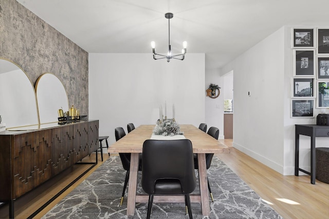 1611 Hill Ridge Ter, Minnetonka, MN 55305 - dining room featuring light wood finished floors, a chandelier, and an accent wall