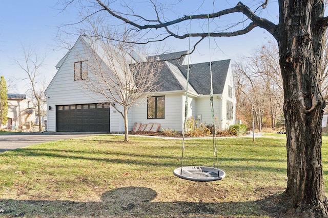 1611 Hill Ridge Ter, Minnetonka, MN 55305 - view of front facade featuring roof with shingles, asphalt driveway, a front yard, and an attached garage