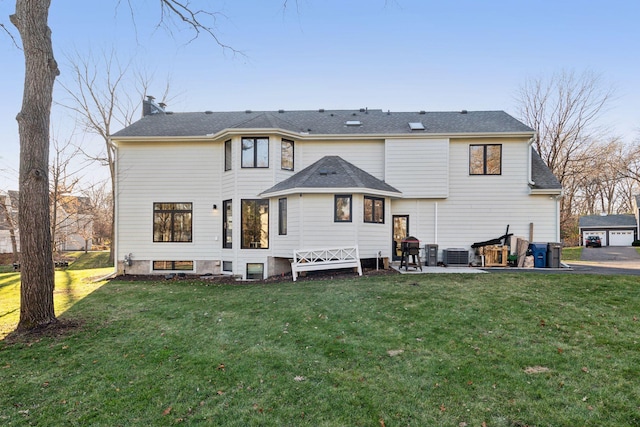 1611 Hill Ridge Ter, Minnetonka, MN 55305 - rear view of house featuring a yard, a patio, a shingled roof, and a chimney