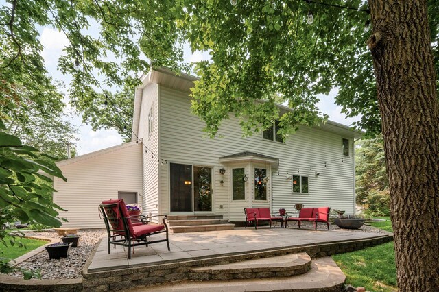 19402 Carson Cir NW, Elk River, MN 55330 - rear view of property with entry steps, a patio area, and outdoor lounge area