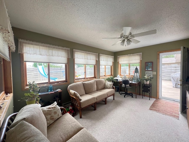 102 Mayfair Ave, New London, MN 56273 - living room featuring a ceiling fan, a textured ceiling, carpet floors, and a baseboard heating unit