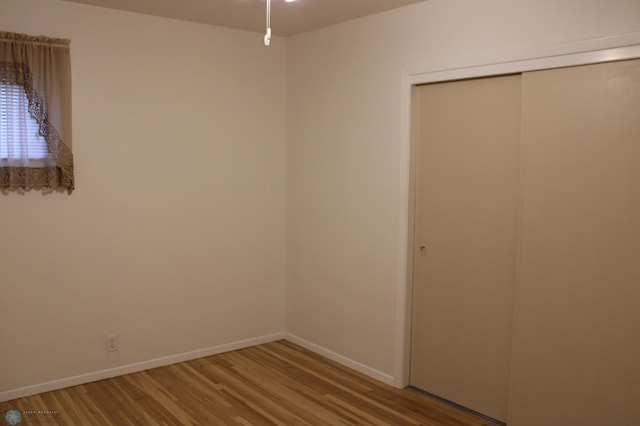 509 24th Ave N, Fargo, ND 58102 - unfurnished bedroom with wood finished floors and a closet