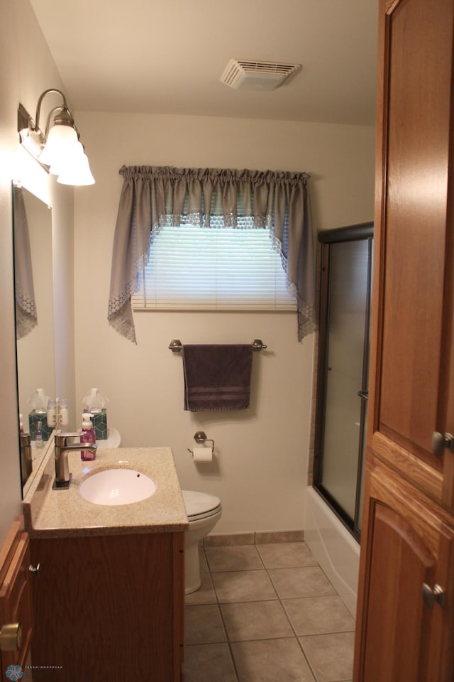 509 24th Ave N, Fargo, ND 58102 - bathroom featuring vanity, tile patterned floors, and bath / shower combo with glass door