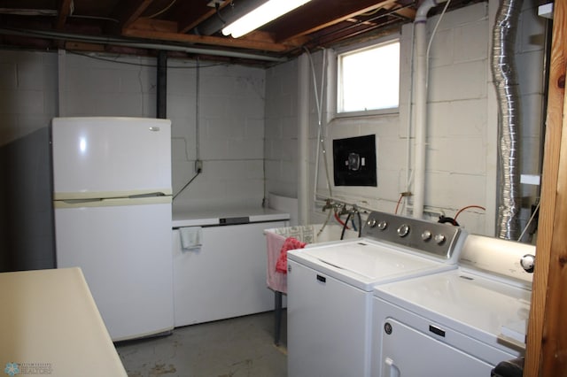 509 24th Ave N, Fargo, ND 58102 - laundry area with separate washer and dryer and concrete block wall