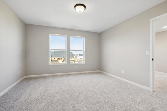 4810 Island Park Dr, Woodbury, MN 55129 - spare room featuring carpet flooring and baseboards
