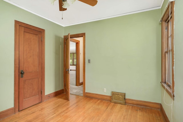 3609 Elliot Ave, Minneapolis, MN 55407 - spare room with light wood-style floors, a ceiling fan, and crown molding