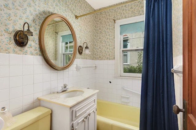 3609 Elliot Ave, Minneapolis, MN 55407 - full bath with wallpapered walls, wainscoting, vanity, and tile walls