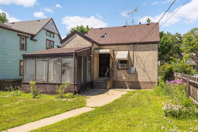 3609 Elliot Ave, Minneapolis, MN 55407 - back of house with a sunroom, roof with shingles, cooling unit, and stucco siding