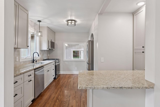 3305 Huntington Ave, Saint Louis Park, MN 55416 - kitchen with appliances with stainless steel finishes, dark wood-type flooring, tasteful backsplash, light stone counters, and white cabinetry