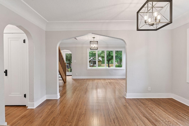 3305 Huntington Ave, Saint Louis Park, MN 55416 - entryway with a chandelier, wood finished floors, stairway, crown molding, and arched walkways