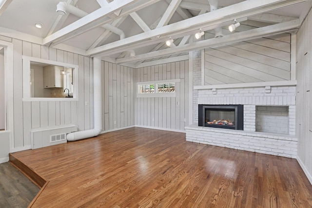 3305 Huntington Ave, Saint Louis Park, MN 55416 - unfurnished living room with wood finished floors, a fireplace, and wooden walls