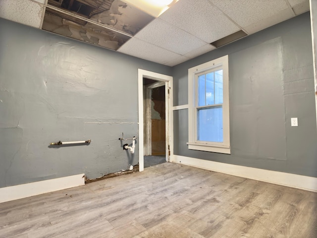 415 College St, Albert Lea, MN 56007 - unfurnished room featuring wood finished floors and a paneled ceiling