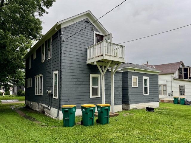 415 College St, Albert Lea, MN 56007 - back of house featuring a balcony and a lawn