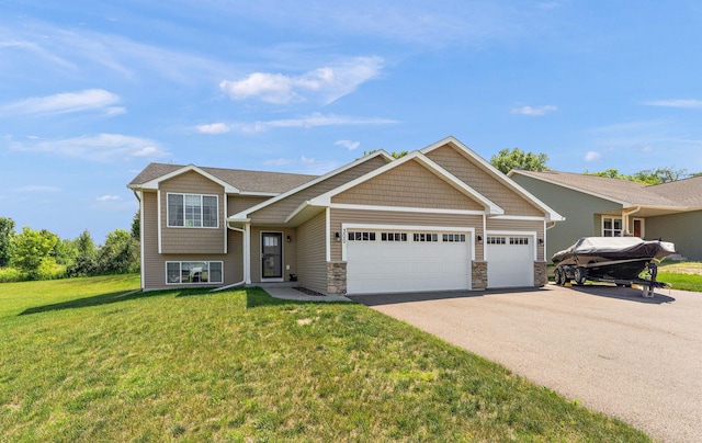 300 Dakota Ave, Roberts, WI 54023 - view of front of home featuring asphalt driveway, a garage, a front lawn, and stone siding