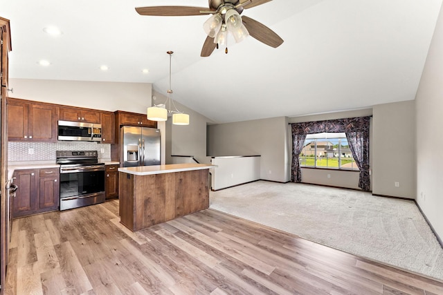 300 Dakota Ave, Roberts, WI 54023 - kitchen with stainless steel appliances, light countertops, a center island, lofted ceiling, and a ceiling fan