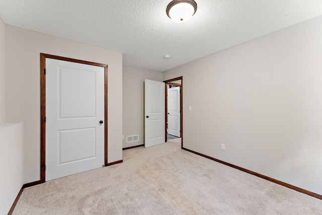 300 Dakota Ave, Roberts, WI 54023 - unfurnished bedroom with light colored carpet and a textured ceiling