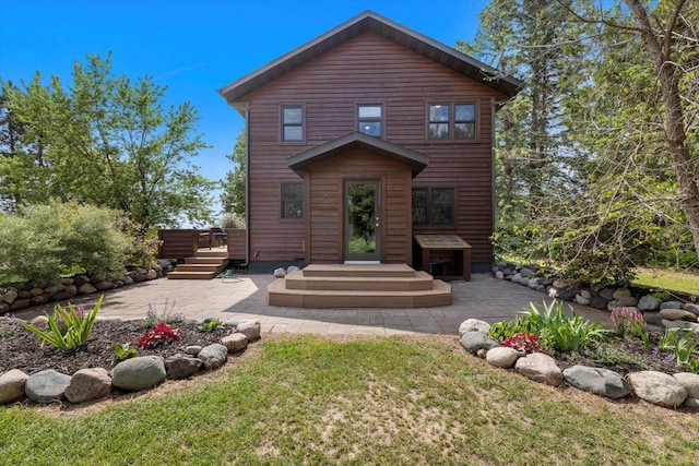 14766 Danson Rd, Splithand Twp, MN 55744 - back of property with a patio area, a yard, and a deck
