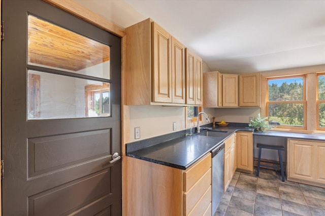 14766 Danson Rd, Splithand Twp, MN 55744 - kitchen featuring light brown cabinets, stainless steel dishwasher, healthy amount of natural light, and dark countertops