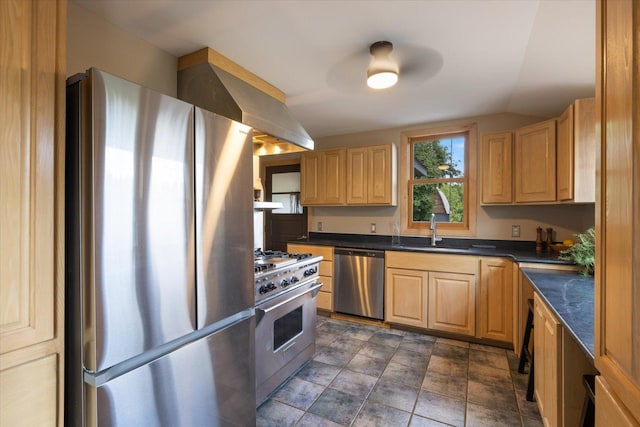 14766 Danson Rd, Splithand Twp, MN 55744 - kitchen featuring appliances with stainless steel finishes, dark countertops, light brown cabinets, lofted ceiling, and wall chimney exhaust hood