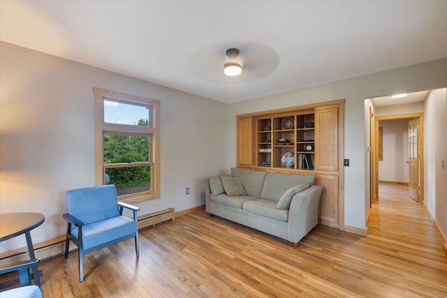 14766 Danson Rd, Splithand Twp, MN 55744 - living area featuring light wood finished floors, a baseboard radiator, and a ceiling fan