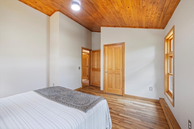 14766 Danson Rd, Splithand Twp, MN 55744 - bedroom with wood ceiling, light wood-style floors, a baseboard radiator, and lofted ceiling