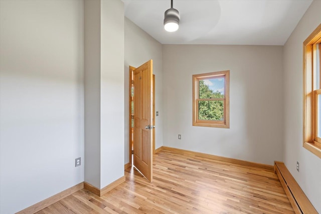 14766 Danson Rd, Splithand Twp, MN 55744 - unfurnished room with baseboard heating, light wood-style floors, and ceiling fan