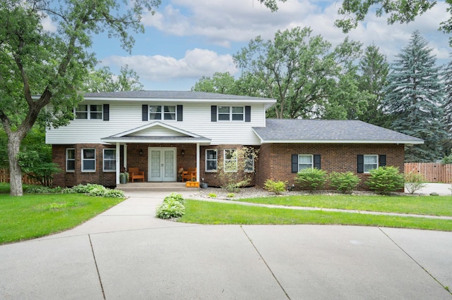 1708 Woodland Rd, Saint Cloud, MN 56304 - view of front of property with french doors, brick siding, and covered porch