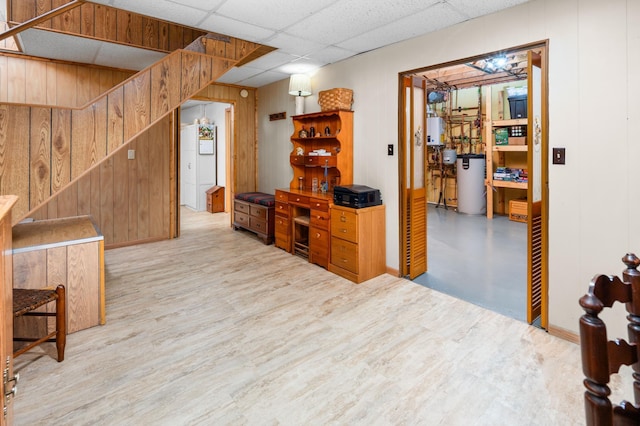 1708 Woodland Rd, Saint Cloud, MN 56304 - interior space featuring wooden walls, stairs, light wood-style flooring, and a paneled ceiling
