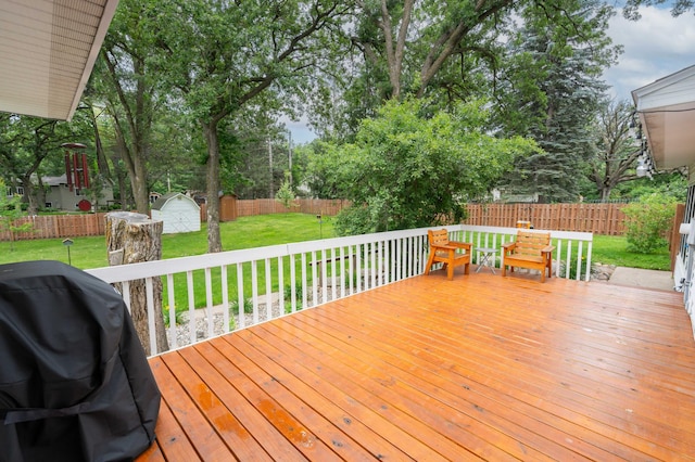 1708 Woodland Rd, Saint Cloud, MN 56304 - deck with grilling area, a storage shed, a fenced backyard, and view of wooded area