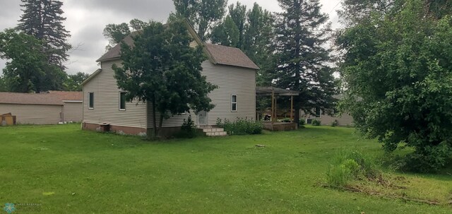 103 Main St S, Kindred, ND 58052 - view of home's exterior featuring a lawn