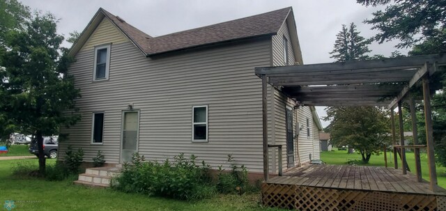 103 Main St S, Kindred, ND 58052 - view of home's exterior with a pergola, a deck, a yard, and roof with shingles