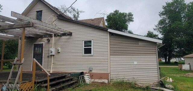 103 Main St S, Kindred, ND 58052 - back of house with a pergola, a deck, and a lawn