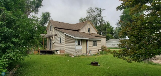 103 Main St S, Kindred, ND 58052 - back of house with a yard and roof with shingles