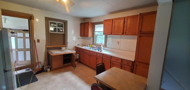 103 Main St S, Kindred, ND 58052 - kitchen featuring brown cabinetry, light countertops, and a ceiling fan