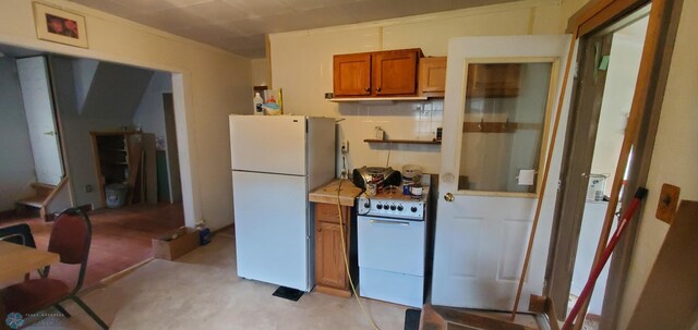 103 Main St S, Kindred, ND 58052 - kitchen featuring white appliances, brown cabinets, and tile counters