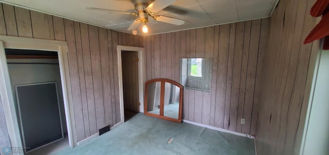 103 Main St S, Kindred, ND 58052 - unfurnished bedroom featuring wood walls and a ceiling fan