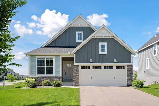 14660 109th Ave N, Maple Grove, MN 55369 - craftsman house with board and batten siding, stone siding, a front lawn, driveway, and a garage