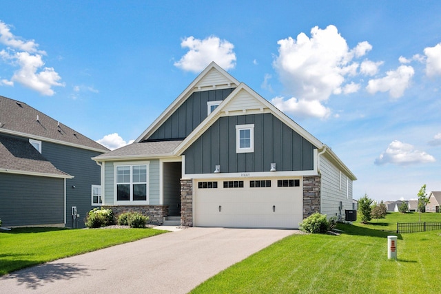14660 109th Ave N, Maple Grove, MN 55369 - view of front of home with board and batten siding, stone siding, driveway, and an attached garage