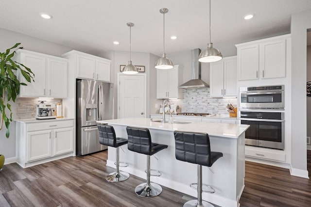 14660 109th Ave N, Maple Grove, MN 55369 - kitchen with stainless steel appliances, wall chimney exhaust hood, decorative backsplash, dark wood-style flooring, and white cabinetry