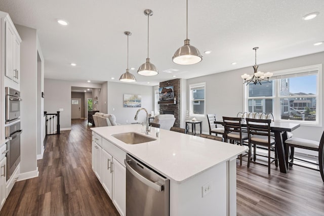 14660 109th Ave N, Maple Grove, MN 55369 - kitchen featuring appliances with stainless steel finishes, open floor plan, dark wood-style floors, recessed lighting, and light countertops