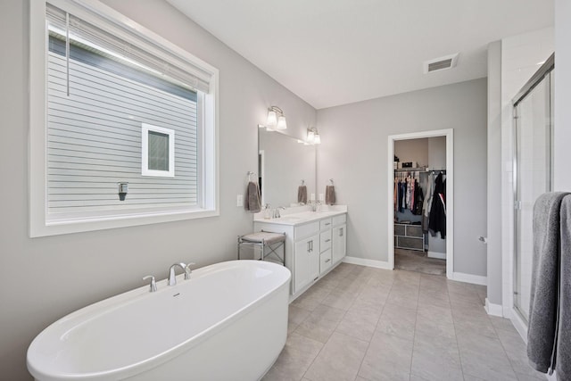 14660 109th Ave N, Maple Grove, MN 55369 - full bath with double vanity, a freestanding bath, a shower stall, and a walk in closet