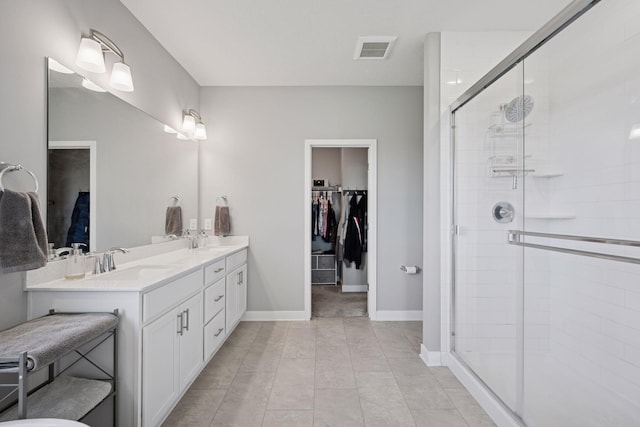 14660 109th Ave N, Maple Grove, MN 55369 - bathroom with double vanity, a stall shower, a spacious closet, and tile patterned flooring