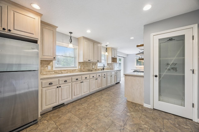 12209 Davenport St NE, Blaine, MN 55449 - kitchen with appliances with stainless steel finishes, tasteful backsplash, light countertops, recessed lighting, and pendant lighting