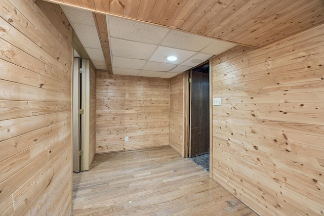 12209 Davenport St NE, Blaine, MN 55449 - hallway featuring wood walls, light wood-style flooring, and a drop ceiling