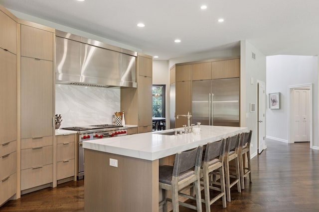2 Red Forest Ln, North Oaks, MN 55127 - kitchen with high quality appliances, wall chimney exhaust hood, modern cabinets, recessed lighting, and light countertops