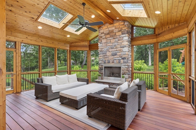 2 Red Forest Ln, North Oaks, MN 55127 - sunroom / solarium featuring a skylight, an outdoor living space with a fireplace, and a ceiling fan